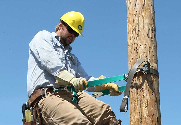 UPPCO worker climbing power pole
