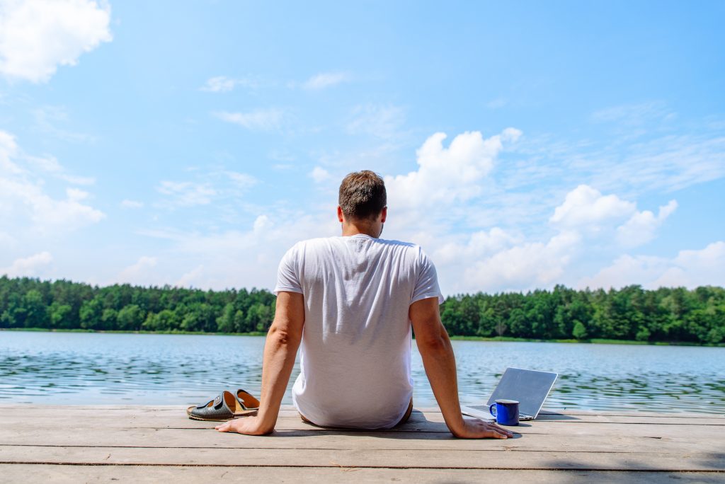 man working on laptop outdoors